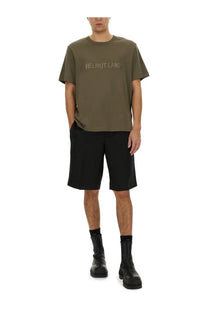 Olive green helmut lang t-shirt with subtle light logo across chest paired with tailored black shorts for men