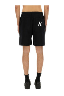 Back side of black helmut lang men’s athletic shorts with white hl logo on the back pocket