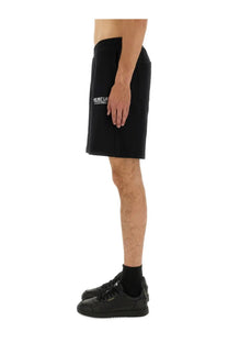 Helmut Lang men’s black shorts featuring a subtle white logo on the left thigh for casual wear
