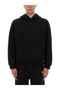 Helmut Lang men’s black hooded sweatshirt with subtle textured logo across chest and large front pocket
