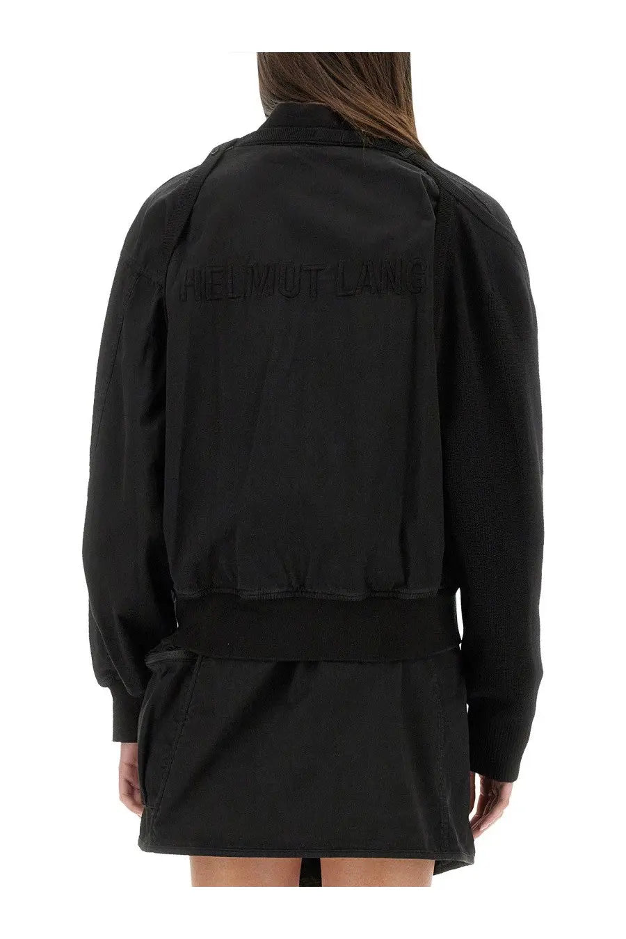 Back view of helmut lang women’s black bomber ma1 jacket with tonal embroidered logo on lightweight nylon material