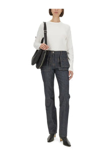 Dark-wash denim jeans with a straight-leg cut and multiple front pockets paired with helmut lang women’s white shirt
