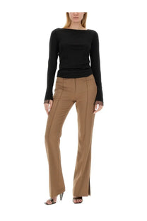 Black long-sleeved top with sheer cuffs and boat neckline paired with helmut lang beige slim fit pants