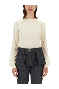 Helmut Lang women’s cream-colored wool jersey top with long sleeves raglan design and subtle seam detailing