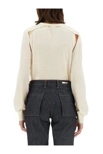 Helmut Lang women’s cream-colored sheer wool jersey blouse with long sleeves and cut-out shoulder details