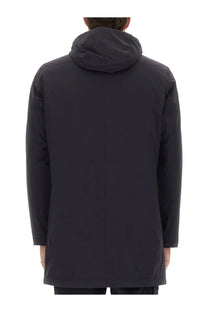 Black hooded trench coat with sleek minimalist design shown from back in herno men’s parka resort blue collection