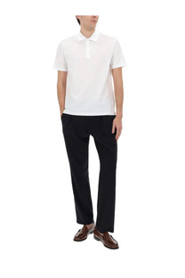 White short-sleeved polo shirt with classic collar paired with herno men’s blue wool blend pants for stylish comfort