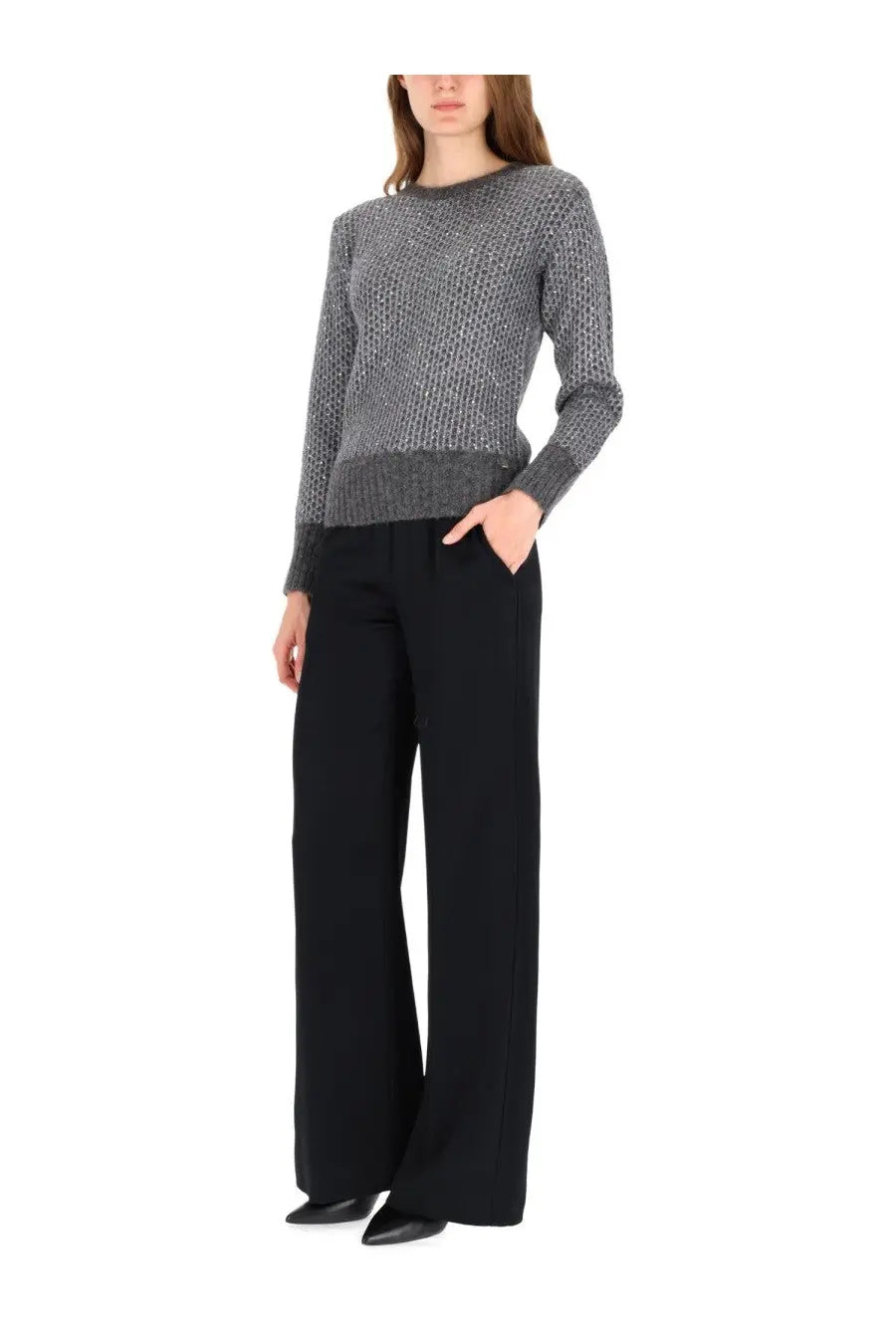 Herno women’s metallic effect sequin grey knit sweater with ribbed hem and cuffs worn over black wide-leg trousers