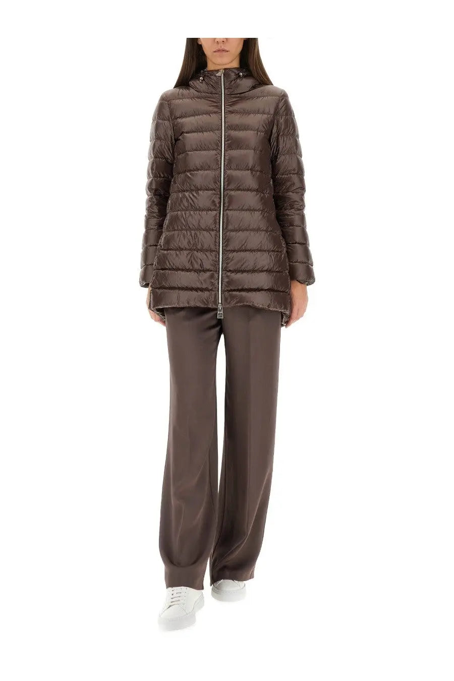 Herno women’s pants resort brown shown with a brown quilted puffer jacket with hood and zipper closure
