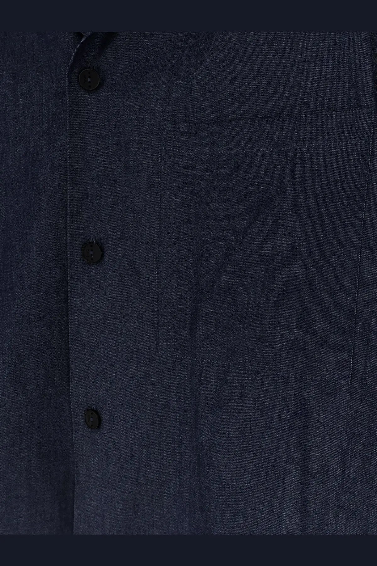 Hevò men’s blue denim shirt with dark blue fabric black buttons and a single chest pocket