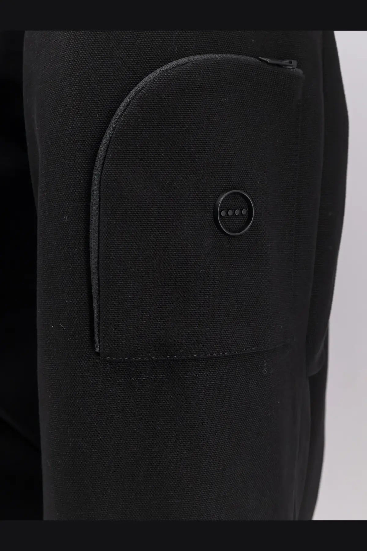 Hevò men’s black cotton bomber jacket paired with black textured fabric pants featuring a curved front pocket and button detail