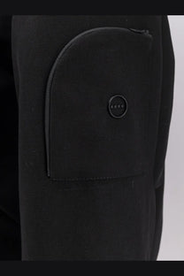 Hevò men’s black cotton bomber jacket paired with black textured fabric pants featuring a curved front pocket and button detail