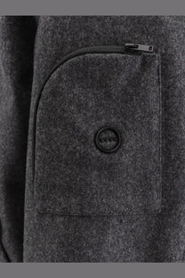 Hevò men’s grottaverde virgin wool blend coat grey showing dark gray woolen pocket with black zipper and brand button