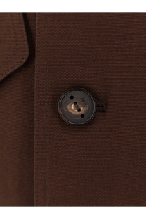 A dark metallic button with worn finish and engraved text on hevò men’s isola di san pietro brown cotton jacket