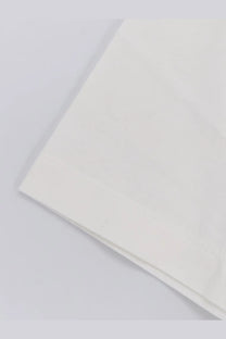 A crisp white hevo men’s mulino cotton shirt with a subtle texture and neatly folded edge pillowcase detail