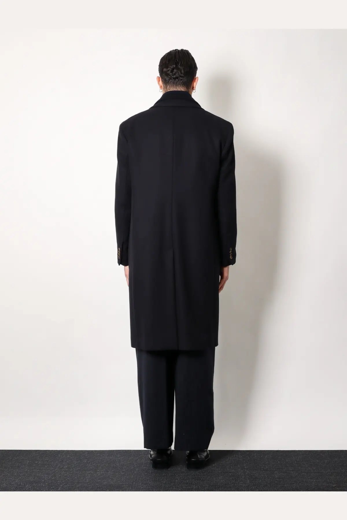 Hevò men’s virgin wool coat blue featuring black wool overcoat with notched lapels and buttoned cuffs front view