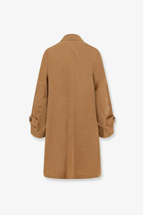 Tan cotton blend trench coat with classic collar buttoned cuffs and straight back seam shown from the back