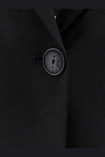A sleek matte black button with a silver rim from hevò womens frigole virgin sheeps wool black suit