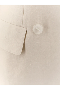 A translucent white button on a textured beige linen and viscose suit from hevò women’s rocchetta collection