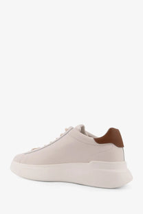 Cream-colored leather hogan men’s sneaker with brown heel tab and thick white rubber sole shown from the back side