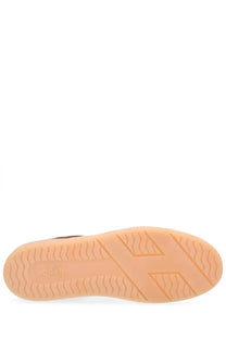 The sole of a Hogan men’s sneaker featuring a light peach rubber outsole with wavy and geometric tread patterns