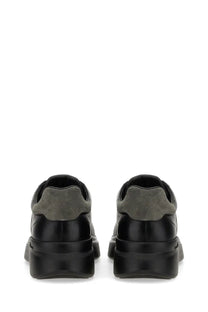 Hogan men’s sneaker h580 black in black and olive green suede and leather with a chunky rubber sole front view