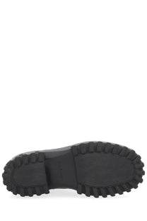 Black rubber sole of hogan womens boot h700 black with rugged chunky tread pattern and textured heel area back view