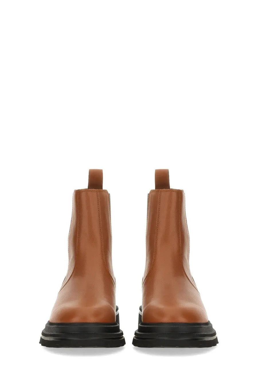 Hogan women’s chelsea boot brown tan leather with black rubber soles showing the back side of the product