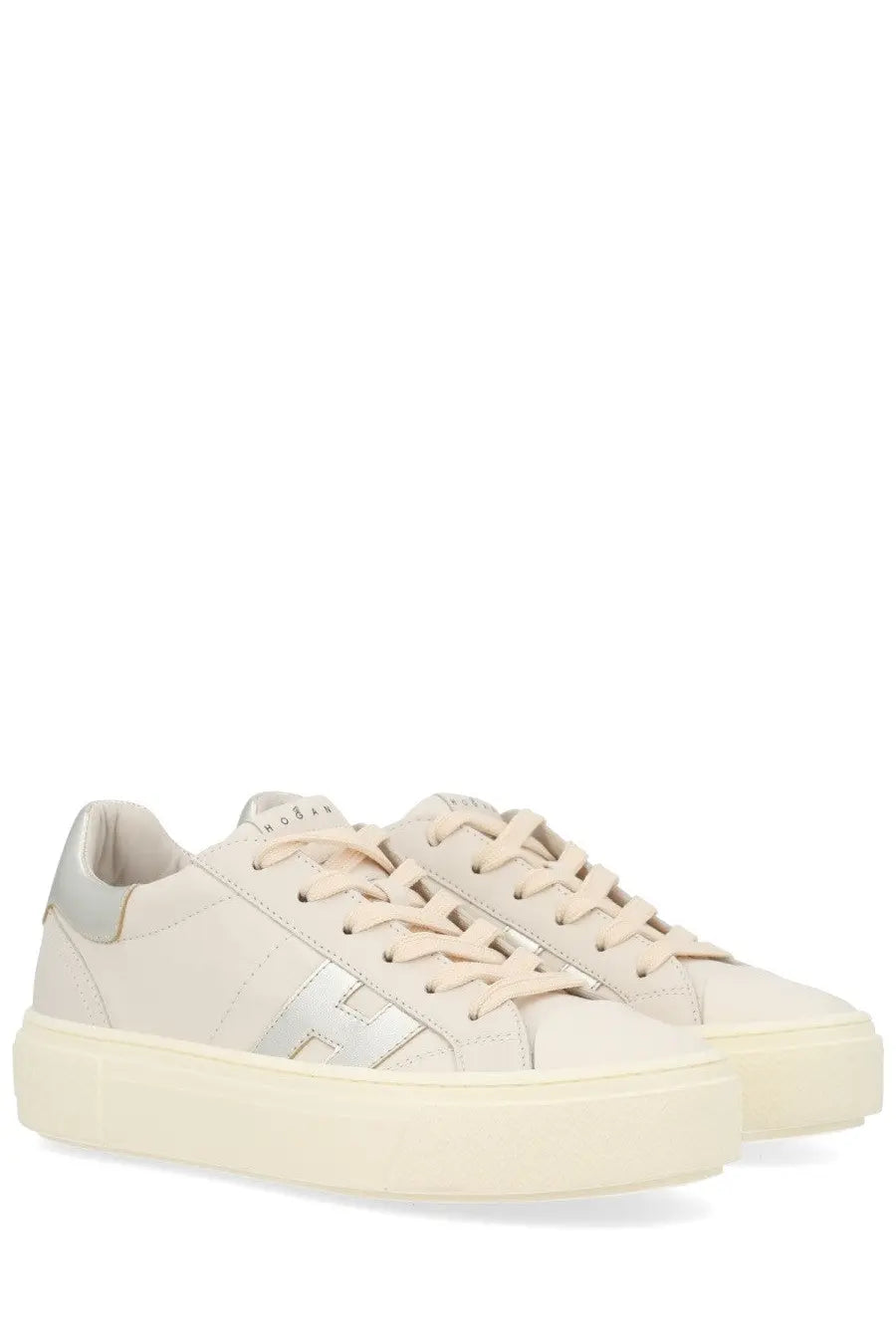 Cream-colored hogan women’s crosswind sneaker with silver logo and platform sole in white