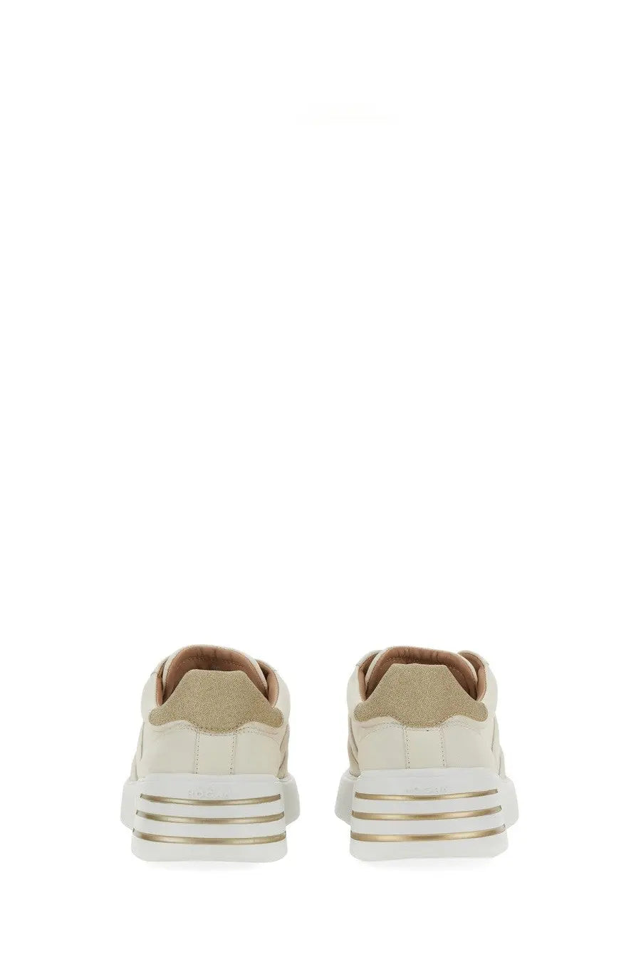 Cream-colored suede hogan women’s rebel sneaker with white rubber sole and gold metallic stripes