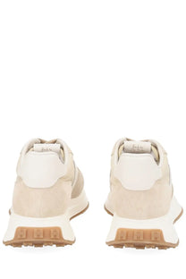 Hogan women’s sneaker beige in beige and white suede with chunky tan rubber sole viewed from the back side