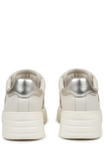 Cream-colored hogan women’s sneaker rebel beige with metallic silver heel tab and chunky white rubber sole back view