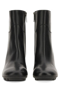 Hogan women’s Stivale H695 black leather ankle boots with sleek glossy finish and subtle stitching details