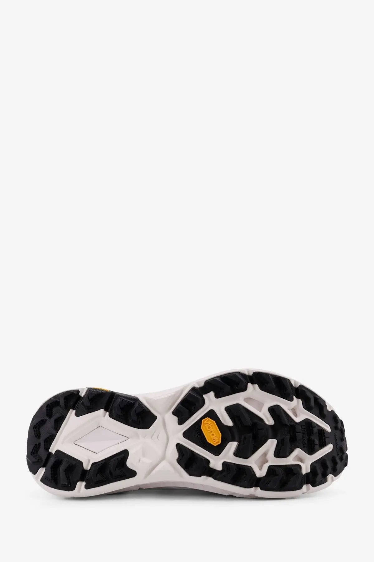 White and black vibram outsole with yellow hexagonal logo on hoka men’s mafate speed lite ts technical fabric sneakers