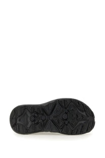 Black rubber sole with geometric tread pattern on the Hoka unisex sneaker Hopara black back side