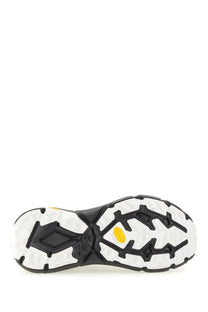 Back side of hoka unisex sneaker mafate speed lite black with black and white rubber sole and yellow vibram logo on heel