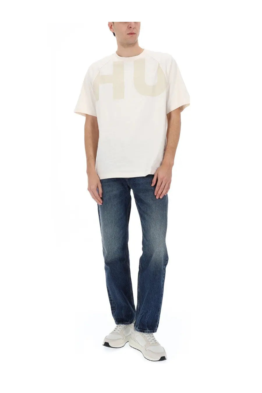 White oversized cotton t-shirt with a large faded beige hu logo paired with hugo boss men’s blue denim jeans