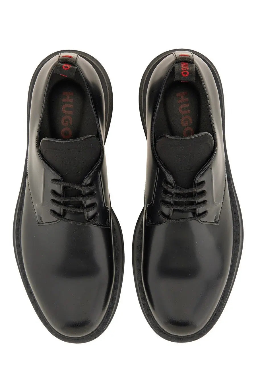 Hugo boss men’s black leather derby loafer with patent leather, chunky sole, lace-up design, and red insole branding