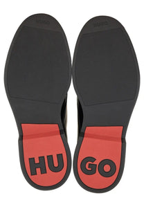 Black and red rubber soles with hugo branding on the heel of hugo boss men’s leather derby loafer black back view