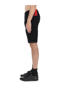 Black denim hugo boss men’s shorts with red brand tag on waistband showing back side design details