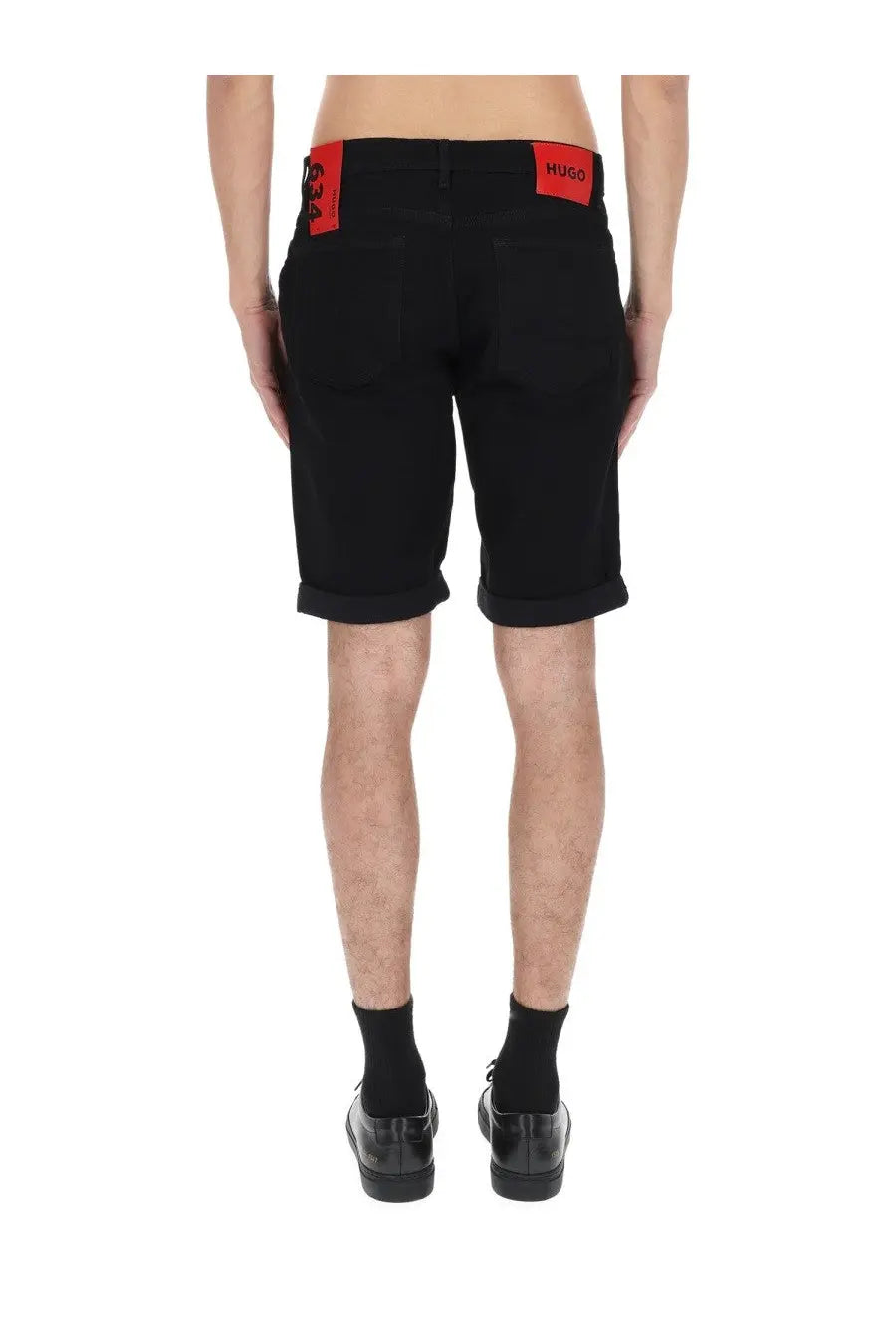 Black hugo boss men’s shorts with red branded patches on the waistband for casual wear
