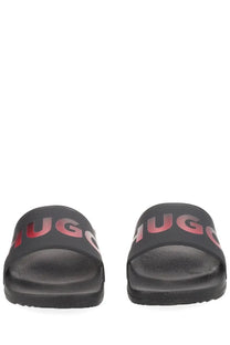 Black hugo boss men’s slide sandals with bold red to pink gradient logo across the strap for casual wear