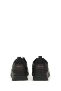 Back view of hugo boss men’s black leather sneakers with red branding on the heel for casual wear