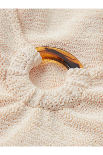A tortoiseshell glossy plastic hair clip with a smooth curved design paired with hunza g womens blue crinkle fabric swimsuit