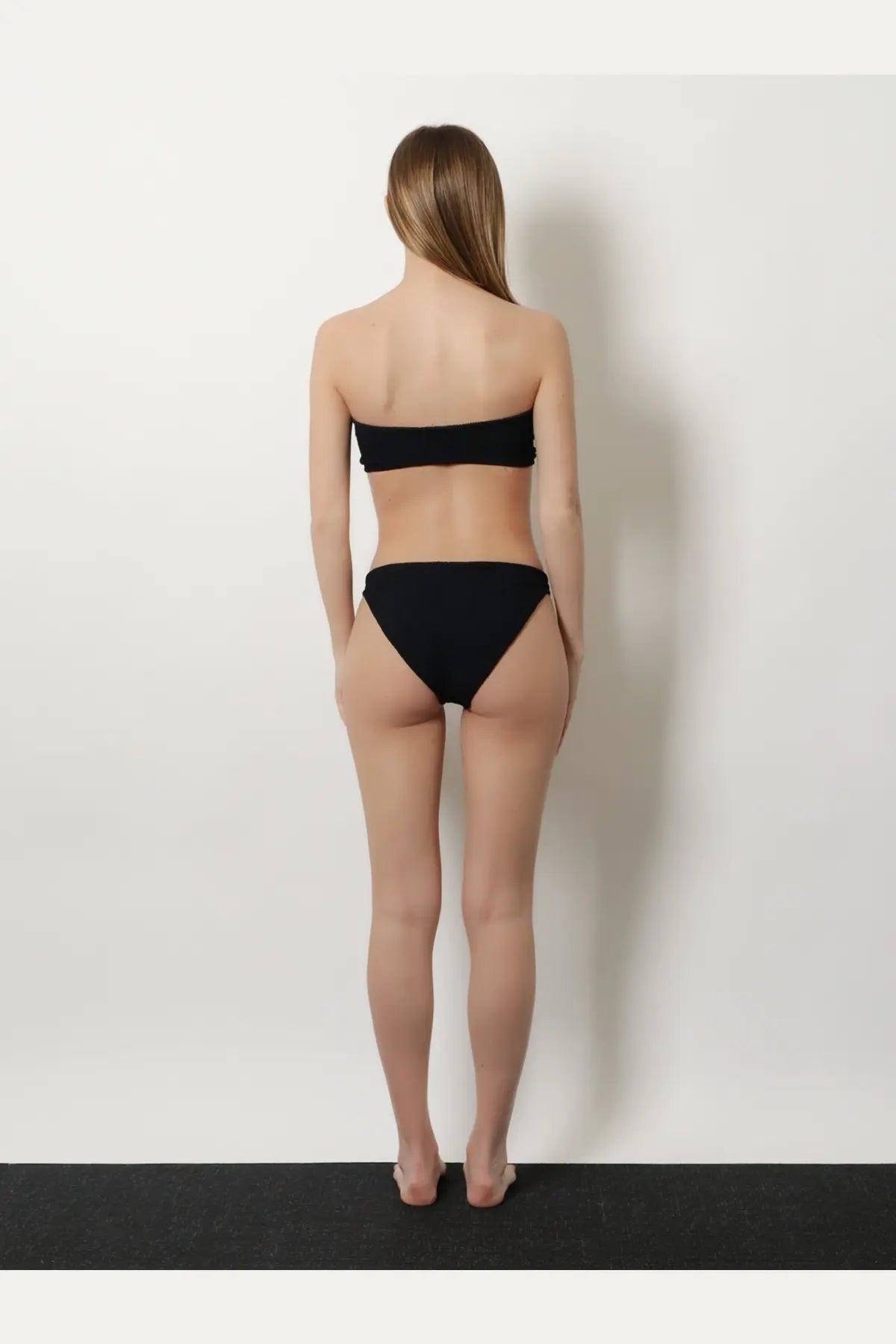 Black strapless crinkle bandeau top and matching high waisted bikini bottoms by Hunza G women’s beachwear