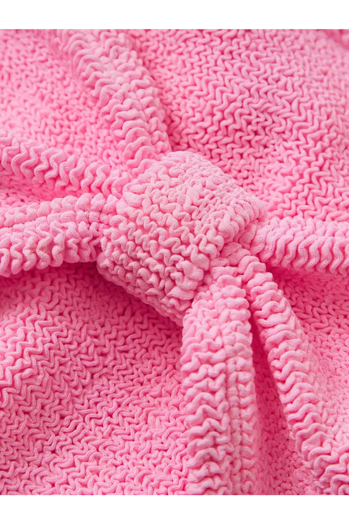 A soft vibrant pink knitted robe with a textured zigzag pattern and matching tied belt for comfortable wear