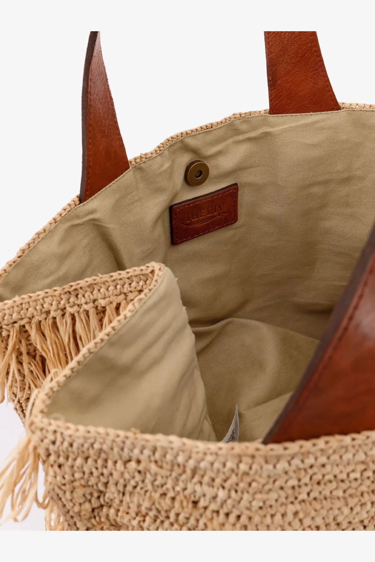 Beige woven straw tote bag with brown leather handles and matching leather brand tag by ibeliv womens onja raffia shoulder bag tea