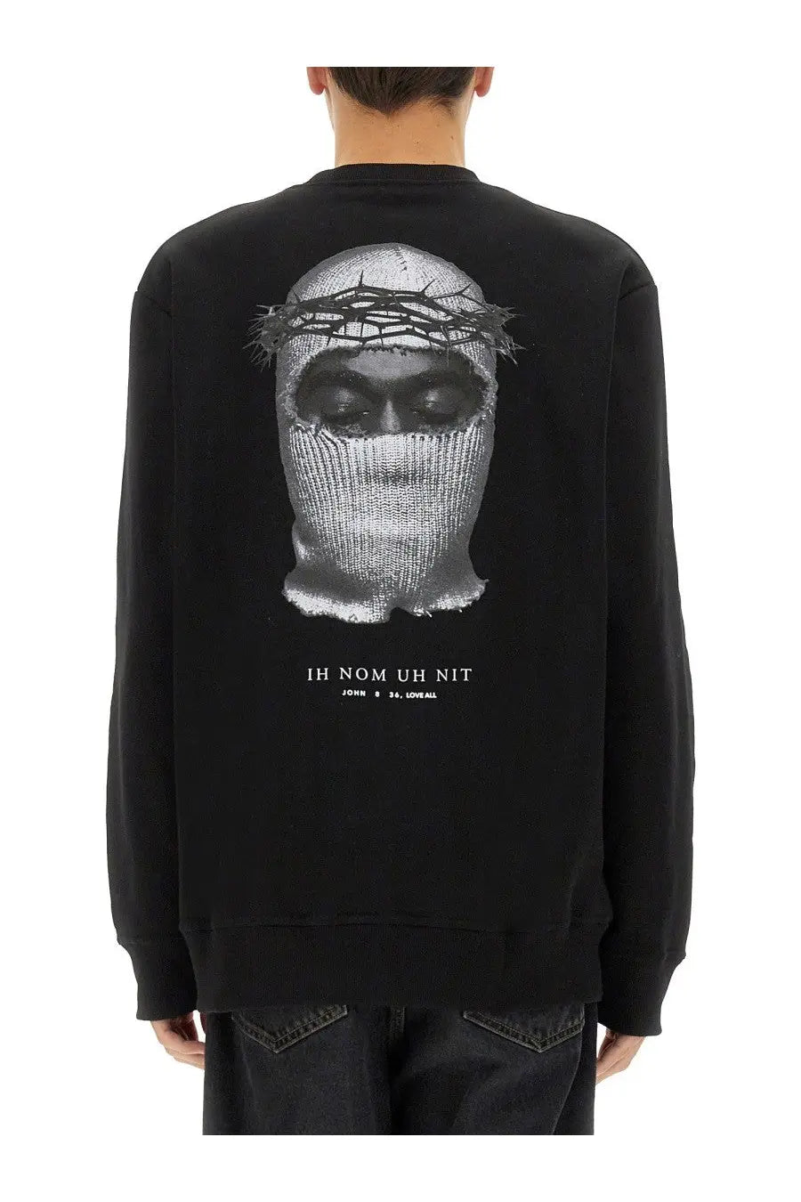 Black long-sleeved sweatshirt featuring a detailed grayscale face in a knit mask with thorns and ih nom uh nit text