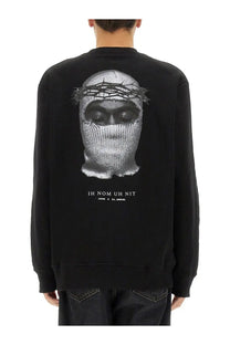 Black long-sleeved sweatshirt featuring a detailed grayscale face in a knit mask with thorns and ih nom uh nit text