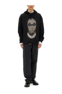 Ih nom uh nit men’s black hoodie with bold leopard print face graphic and silver chain necklace detail